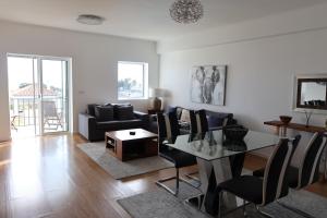 a living room with a table and a couch at CASA SIMBA , where the fun begins in Ponta Delgada