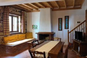 a living room with a wooden table and a fireplace at Alexis new villas in Chrysi Ammoudia