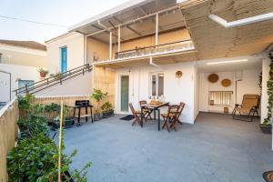 an outdoor patio with a table and chairs at Vasiliko House in Kalavárda