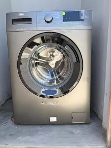 a washing machine is sitting in a room at Evangeline House in Cape Town