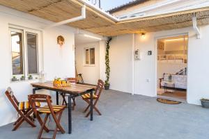 a patio with a wooden table and chairs at Vasiliko House in Kalavárda