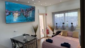 a living room with a bed and a couch at Un Tuffo nello Stretto in Villa San Giovanni