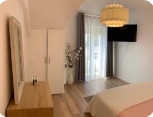 a bedroom with a bed and a vase of flowers at Ourmes 1 Apartment in Guipry-Messac