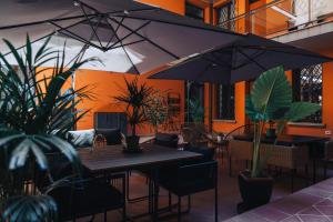 an outdoor patio with tables and chairs and plants at Portico Provenzali in Cento