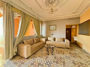 a living room with a couch and a table at Marrakech ferme lodge in Marrakesh +37 photos