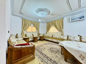 a living room with a bed and a couch at Marrakech ferme lodge in Marrakesh