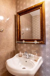 a white sink in a bathroom with a mirror at Velev House in Melnik +114 photos