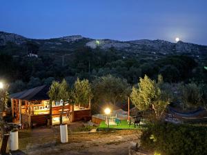a view of a house at night with the mountains at Villa Rosa in Surrau in Arzachena