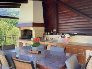 a kitchen with a table and a stove at Villa Bambi in Mošćenička Draga