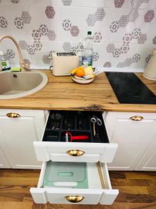 a kitchen with a stove top oven in a counter at November Central Studio in Lugoj