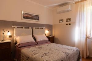 a bedroom with a large bed and a window at Casa Angolo delle Rose 2 in Orvieto