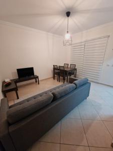 a living room with a couch and a table at Cabanas Family Apartment in Cabanas de Tavira