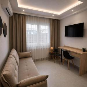 a living room with a couch and a desk at Malama's apartment in Neos Marmaras