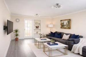 a living room with a couch and two tables at Nayla House Cozy 4BR with Garden & Parking in Moffat