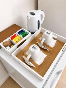 a drawer with two cups and utensils on a table at Atenè Rooms in Agrigento