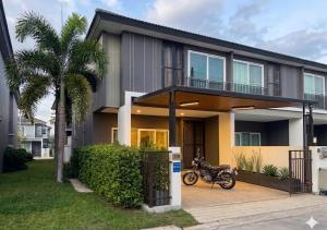 a motorcycle parked in front of a house at SvoyLuX Primo 3BR Gated House Near Pier and Muay Thai Street in Phuket