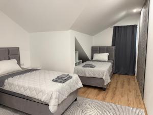 a bedroom with two beds and a rug at URBAN House Vienna in Gerasdorf bei Wien