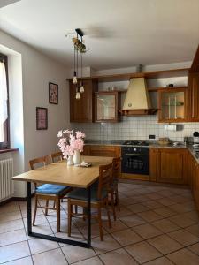 a kitchen with a wooden table and chairs at Casa Chiara in Mandello del Lario
