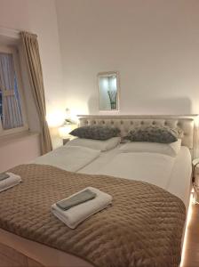 a bedroom with two beds with towels on them at Dalti Center Apartment in Zadar