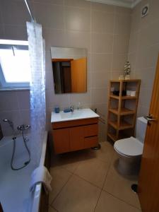 a bathroom with a sink and a toilet and a shower at Cabanas Family Apartment in Cabanas de Tavira +16 photos