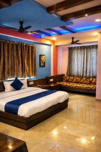 a bedroom with a king sized bed and a couch at FabHotel BD Colaba in Mumbai