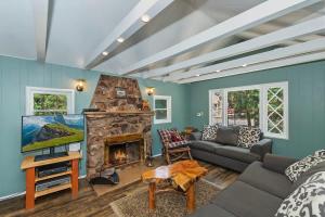 a living room with a couch and a fireplace at Applewood Cabins & Guest Cabin Near the Village in Big Bear Lake