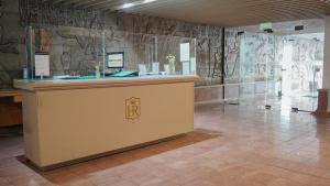 a lobby with a counter with graffiti on the walls at Hotel Royal in Neuquén