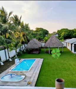 a resort with a swimming pool and a grass yard at Finca la Esperanza in Guadalupe