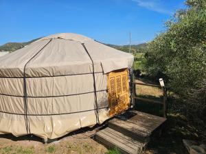 a yurt with a door in the middle of a field at Yourte Corsica vera in Appietto +4 photos