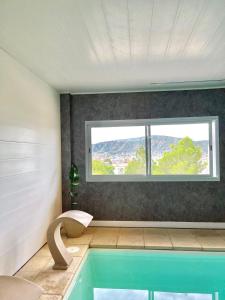 a bathroom with a swimming pool with a window at Alamo Hotel in Villa Carlos Paz