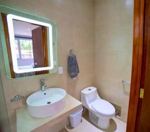 a bathroom with a sink and a toilet and a mirror at MRE Goldsmith Polanco in Mexico City