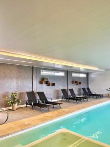 a swimming pool with lounge chairs and a swimming pool at Alamo Hotel in Villa Carlos Paz