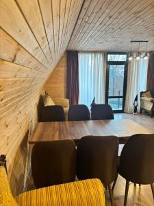 a conference room with a large wooden table and chairs at Sisters House in Borjomi