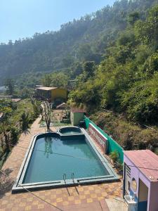 a swimming pool on top of a building with a mountain at LA Foresta resort by Utopia in Shivpuri