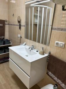 a bathroom with a white sink and a mirror at Apartment zona Naturista in Vera +67 photos