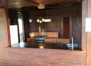 a kitchen with a stove and a counter top at Casa de Madeira Atins 2 bedrooms in Atins +7 photos