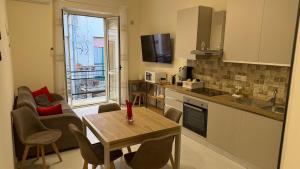 a kitchen and living room with a table and chairs at La casa dei desideri in Pizzo
