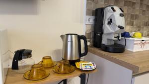 a counter with a coffee maker on a shelf at La casa dei desideri in Pizzo