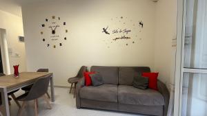 a living room with a couch and a clock on the wall at La casa dei desideri in Pizzo +22 photos