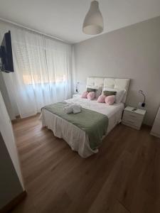 a bedroom with a large bed with pink pillows at Monte y mar in Bueu