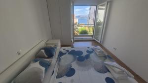 a small room with a bed with a window at Take it slow in Postira