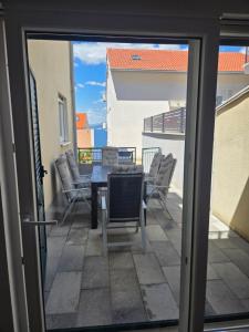 a view of a patio from a sliding glass door at Take it slow in Postira