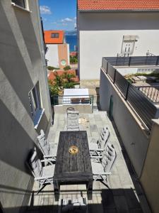 a table and chairs on the balcony of a building at Take it slow in Postira