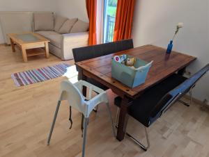 a wooden table and chairs in a living room at Ferienwohnung Weiding in Rutzenmoos