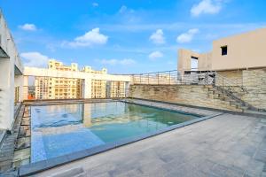 a swimming pool on the roof of a building at The Zean Luxury in Jāmb