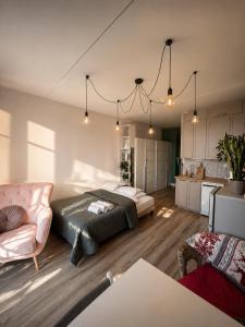 a bedroom with a bed and a living room at MIŁO Apartament Zarembowicza in Wrocław