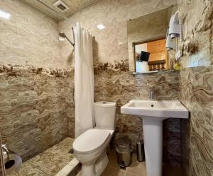 a bathroom with a toilet and a sink at Кирч Горис in Goris