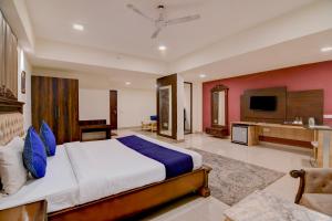 a bedroom with a large bed and a television at The Zean Luxury in Jāmb