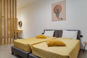 a bedroom with a bed with two pillows on it at Casa Dionysia - New Lux 2Br with Jacuzzi near Maleme Beach in Maleme