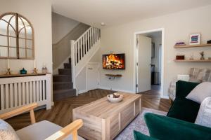 a living room with a couch and a fireplace at The Willows in Hurlet
